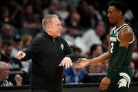 CHARLOTTE, NORTH CAROLINA - MARCH 21: Head coach Tom Izzo of the Michigan State Spartans talks with Tyson Walker #2 against the Mississippi State Bulldogs during the second half in the first round of the NCAA Men's Basketball Tournament at Spectrum Center on March 21, 2024 in Charlotte, North Carolina. (Photo by Jacob Kupferman/Getty Images)