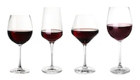 Set with glasses of red wine on white background