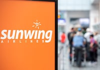 Travellers wait in line at a Sunwing Airlines check-in desk at Trudeau Airport in Montreal, Wednesday, April 20, 2022.THE CANADIAN PRESS/Graham Hughes