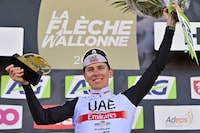 Slovenian Tadej Pogacar of UAE Team Emirates celebrates on the podium after winning the 86th edition of the men's race 'La Fleche Wallonne', a one day cycling race (Waalse Pijl - Walloon Arrow), 194,2 km from Herve to Huy on April 19, 2023. (Photo by DIRK WAEM / Belga / AFP) / Belgium OUT (Photo by DIRK WAEM/Belga/AFP via Getty Images)