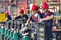 Employees work on an engine assembly line at an engine manufacturing factory in Qingzhou, in China's eastern Shandong province on April 16, 2024. (Photo by AFP) / China OUT (Photo by STR/AFP via Getty Images)