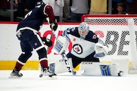 Apr 13, 2023; Denver, Colorado, USA; Winnipeg Jets goaltender David Rittich (33) makes a penalty shot save on Colorado Avalanche center Lars Eller (20) in the third period at Ball Arena. Mandatory Credit: Ron Chenoy-USA TODAY Sports