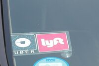 FILE PHOTO: The Uber and Lyft logos are seen on a vehicle in Manhattan, New York, U.S., July 27, 2018.  REUTERS/Shannon Stapleton/File Photo