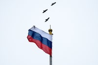 (FILES) In this file photo taken on January 21, 2020 crows fly close to a Russian flag at the top of the Russian Government building in downtown Moscow. - Russia's economic growth slowed to 1.3 percent last year, the state statistics agency said on February 3, 2020, with the lethargic pace presenting a major headache for the Kremlin. (Photo by Kirill KUDRYAVTSEV / AFP) (Photo by KIRILL KUDRYAVTSEV/AFP via Getty Images)