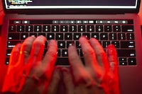 A man uses a computer keyboard in Toronto in this Sunday, Oct. 9, 2023 photo illustration. A town in Ontario's Muskoka region has shared more details about a cybersecurity incident earlier this month. THE CANADIAN PRESS/Graeme Roy