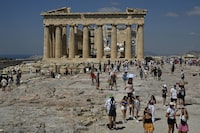 (FILES) Tourists visit the Acropolis in Athens on June 14, 2023. Greece in 2025 will raise ticket prices to the Acropolis, its most popular ancient monument, the culture minister said on December 20, 2023. (Photo by Louisa GOULIAMAKI / AFP) (Photo by LOUISA GOULIAMAKI/AFP via Getty Images)