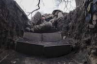 A Ukrainian soldier takes a rest in a trench on the frontline near Liman, Lyman, Donetsk region, Ukraine, Friday, March 29, 2024. (Iryna Rybakova via AP)
