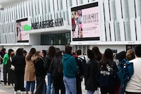 Fans of US singer Taylor Swift queue to get merchandise, a day prior to the start of the pop star's concerts at the Paris La Defense Arena as part of her The Eras Tour, in Nanterre, north-western France, on May 8, 2024. (Photo by MIGUEL MEDINA / AFP) (Photo by MIGUEL MEDINA/AFP via Getty Images)