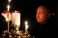 In this pool photograph distributed by the Russian state agency Sputnik, Russia's President Vladimir Putin lights a candle during his visit to a church of the Novo-Ogaryovo state residence outside Moscow on March 24, 2024, during a national day of mourning following the attack in the Crocus City Hall, which has been claimed by the Islamic State (IS) group. Camouflaged assailants opened fire at the packed Crocus City Hall in Moscow's northern suburb of Krasnogorsk on March 22, 2024, ahead of a concert by Soviet-era rock band Piknik in the deadliest attack in Russia for at least a decade. (Photo by Mikhail METZEL / POOL / AFP) (Photo by MIKHAIL METZEL/POOL/AFP via Getty Images)