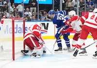 Apr 13, 2024; Toronto, Ontario, CAN; Toronto Maple Leafs center Auston Matthews (34) battles for the puck with Detroit Red Wings left wing J.T. Compher (37) during the third period at Scotiabank Arena. Mandatory Credit: Nick Turchiaro-USA TODAY Sports