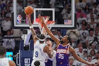 Apr 23, 2024; Minneapolis, Minnesota, USA; Minnesota Timberwolves guard Nickeil Alexander-Walker (9) shoots against Phoenix Suns forward Kevin Durant (35) in the second quarter during game two of the first round for the 2024 NBA playoffs at Target Center. Mandatory Credit: Brad Rempel-USA TODAY Sports