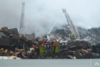 The mayor of Saint John, N.B., says a fire at a recycling plant in the city is contained and the shelter-in-place advisory has been lifted. Firefighters battle a blaze on Thursday, Sept. 14, 2023, at a metal recycling yard along the harbour in Saint John. THE CANADIAN PRESS/Michael Hawkins