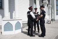 Deputy Chief Robertson Rouse of the York Regional Police (left) and Insp. Charles Byham (centre) speak with a colleague outside the Islamic Society of Markham following a news conference about an alleged hate incident in Markham, Ont. on Monday, April 10, 2023. Mosques across Canada have increasingly had to ask congregants to stay vigilant against potential attacks and harassment during the holy month of Ramadan, Muslim advocacy groups say, noting that the normalization of such security conversations is a concern. THE CANADIAN PRESS/Chris Young