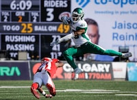 Saskatchewan Roughriders running back Jamal Morrow, right, leaps away from Calgary Stampeders defensive back Tre Roberson during first half CFL football action in Calgary, Alta., Saturday, June 24, 2023. Doing his part to secure the Saskatchewan Roughriders a Grey Cup title remains Morrow’s top priority. THE CANADIAN PRESS/Jeff McIntosh