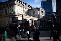 People walk outside the Bank of England in the City of London financial district in London, Britain, March 23, 2023. REUTERS/Henry Nicholls