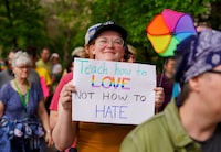 A person holds a sign during a pride rally in Saskatoon, Sask., on Thursday, June 1, 2023. THE CANADIAN PRESS/Heywood Yu