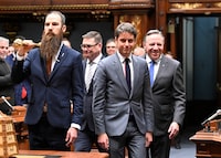 The Prime Minister of France Gabriel Attal, centre, walks in the Salon Bleu of the National Assembly, followed by Quebec Premier Francois Legault, right, at the legislature in Quebec City, Thursday, April 11, 2024. THE CANADIAN PRESS/Jacques Boissinot