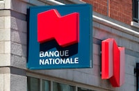 A National Bank sign is seen Monday, May 30, 2016 in Montreal. National Bank of Canada raised its quarterly dividend as it reported its fourth-quarter profit rose to $604 million compared with $566 million in the same period a year ago. THE CANADIAN PRESS/Paul Chiasson