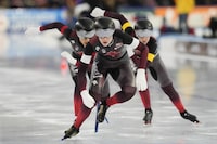 Team Canada with Carolina Hiller, left, Brooklyn MCDougall, center, and Ivanie Blondin of Canada, right, compete to win the women's Team Sprint of the Speedskating Single Distance World Championships at Thialf ice arena Heerenveen, Netherlands, Thursday, March 2, 2023. (AP Photo/Peter Dejong)