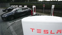 A Tesla vehicles charge, Wednesday, Sept. 27, 2023, in Woodstock, Ga.