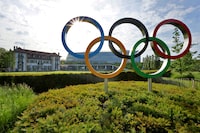 FILE PHOTO: The Olympic rings are pictured in front of the International Olympic Committee (IOC) headquarters in Lausanne, Switzerland, May 17, 2022. REUTERS/Denis Balibouse/File Photo