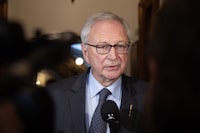 Premier Blaine Higgs speaks to reporters at the New Brunswick Legislative Building after his government delivered the throne speech in Fredericton, Tuesday, Oct. 17, 2023. Higgs' majority government has survived a non-confidence vote in the legislature.THE CANADIAN PRESS/Ron Ward