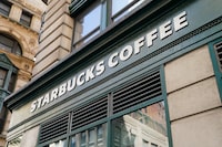 A Starbucks sign is displayed above a store in the Financial District of Lower Manhattan, Tuesday, June 13.