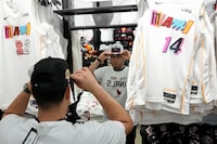 Miami Heat basketball fan Carlos Ramos, 22, shops for team gear Monday, June 5, 2023, at Dadeland Mall in Miami. On Tuesday, the Conference Board reports on U.S. consumer confidence for July. (AP Photo/Rebecca Blackwell)