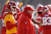 Kansas City Chiefs quarterback Patrick Mahomes, right, and head coach Andy Reid watch practice for Super Bowl 58 Friday, Feb. 9, 2024 in Henderson, Nev. The Chiefs will play the NFL football game against the San Francisco 49ers Sunday in Las Vegas. (AP Photo/Charlie Riedel)