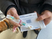 A patient displays medications and a $50 cash kickback that a pharmacy employee delivered to him, in violation of College of Pharmacists of B.C. bylaws, on Feb. 6, 2024, in Vancouver. The man tells The Globe and Mail that the pharmacy pays him $50 per week and does not change his fentanyl patches, as ordered by his doctor. 