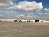 FILE PHOTO: Military vehicles of U.S. soldiers are seen at the al-Asad air base in Anbar province, Iraq, January 13, 2020. REUTERS/John Davison/File Photo