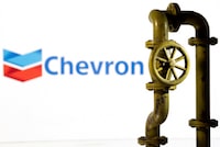 FILE PHOTO: A 3D printed natural gas pipeline is placed in front of displayed Chevron logo in this illustration taken Feb. 8, 2022. REUTERS/Dado Ruvic/Illustration/File Photo