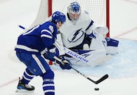 Toronto Maple Leafs forward John Tavares (91) moves in on Tampa Bay Lightning goaltender Andrei Vasilevskiy (88) during third period NHL first round Stanley Cup playoff hockey action in Toronto, on Thursday, April 20, 2023. THE CANADIAN PRESS/Nathan Denette
