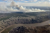 This aerial handout picture courtesy of the Alberta Wildfire Service, taken May 11, 2024, shows smoke from wildfires burning 16km SW of the town of Fort McMurray, in Alberta, Canada. (Photo by Handout / Alberta Wildfire Service / AFP) / RESTRICTED TO EDITORIAL USE - MANDATORY CREDIT "AFP PHOTO / Alberta Wildfire Service / Handout" - NO MARKETING NO ADVERTISING CAMPAIGNS - DISTRIBUTED AS A SERVICE TO CLIENTS (Photo by HANDOUT/Alberta Wildfire Service/AFP via Getty Images)
