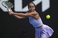 Leylah Fernandez of Canada plays a backhand return to Alycia Parks of the U.S. during their second round match at the Australian Open tennis championships at Melbourne Park, Melbourne, Australia, Wednesday, Jan. 17, 2024. (AP Photo/Alessandra Tarantino)
