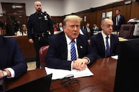 Former US President Donald Trump (C) looks on during his criminal trial for allegedly covering up hush money payments at Manhattan Criminal Court, in New York City, on May 13, 2024. Donald Trump's criminal trial in New York was expected to hear his former lawyer turned tormentor Michael Cohen testify Monday about his role in what prosecutors say was a cover up of payments to hide an affair. (Photo by Spencer Platt / POOL / AFP) (Photo by SPENCER PLATT/POOL/AFP via Getty Images)