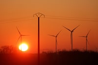FILE PHOTO: Power-generating windmill turbines are pictured at sunrise at a wind park in Avesnes-le-Sec, France, April 3, 2023. REUTERS/Pascal Rossignol