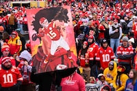 A man carries a portrait of Kansas City Chiefs quarterback Patrick Mahomes through the crowd during the Chiefs' victory celebration and parade in Kansas City, Mo., Wednesday, Feb. 15, 2023.  The Chiefs defeated the Philadelphia Eagles Sunday in the NFL Super Bowl 57 football game. (AP Photo/Reed Hoffmann)