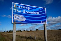 A Ontario Greenbelt sign is shown as itÕs surrounded by farm land near Caledon, Ont., on Thursday, October 12, 2023. The Greenbelt is a protected area of green space, farmland, forests, wetlands, and watersheds, located in Southern Ontario, Canada. THE CANADIAN PRESS/Nathan Denette