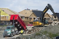 The Canada Mortgage and Housing Corp. says construction of new homes in Canada's six largest cities remained stable at near all-time high levels last year, driven by a surge of new apartment starts despite demand still outpacing supply for rental housing. New homes are built in Ottawa on Monday, Aug. 14, 2023. THE CANADIAN PRESS/Sean Kilpatrick