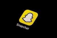FILE - The icon for Snapchat is seen on a smartphone, Feb. 28, 2023, in Marple Township, Pa. Investigators in Massachusetts are pursuing criminal charges against six teens who they say participated in “a hateful, racist online chat that included heinous language, threats, and a mock slave auction” using Snapchat. (AP Photo/Matt Slocum, File)