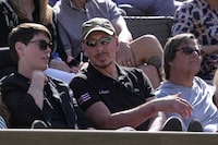 File - Oracle cofounder Larry Ellison, middle, watches a match at the BNP Paribas Open tennis tournament on March 18, 2023, in Indian Wells, Calif. A recent report from anti-poverty organization Oxfam highlighted how the fortunes of the world's five richest people — Tesla CEO Elon Musk, Amazon founder Jeff Bezos, Ellison, Bernard Arnault of luxury company LVMH, and investment guru Warren Buffett — have more than doubled since 2020. (AP Photo/Mark J. Terrill, File)
