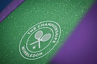 Wimbledon umbrellas covered in rain drops are pictured on court 2 as the tennis matches have been suspended due to the rain on the second day of the 2023 Wimbledon Championships at The All England Tennis Club in Wimbledon, southwest London, on July 4, 2023. (Photo by Glyn KIRK / AFP) / RESTRICTED TO EDITORIAL USE (Photo by GLYN KIRK/AFP via Getty Images)