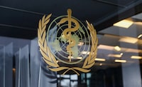 FILE PHOTO: The World Health Organization logo is pictured at the entrance of the WHO building, in Geneva, Switzerland, December 20, 2021. REUTERS/Denis Balibouse/