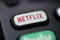 After announcing last year that it would no longer offer the $9.99 plan to new or returning subscribers, the streaming giant is phasing out the price level entirely for users who were grandfathered into the plan. The Netflix logo is pictured on a remote control in Portland, Ore., Aug. 13, 2020. THE CANADIAN PRESS/AP-Jenny Kane