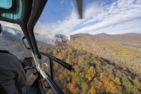 This photo provided by Virginia Department of Forestry shows the fire breached a spot in the containment lines and is slowly expanding into Shenandoah National Park and The Rapidan Tract of the Rapidan Wildlife Management Area on Nov. 5, 2023. The state Department of Forestry said a wildfire near Madison County has led officials to encourage some residents to evacuate as crews work to stop the blaze from spreading. That fire had burned nearly 2,500 acres (1,012 hectares) on Sunday, but no structures have been affected and firefighters were installing additional fire lines to maintain that, the agency said. (Virginia Department of Forestry via AP)