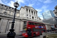 FILE PHOTO: A bus passes the Bank of England in the City of London, Britain, February 14, 2017. REUTERS/Hannah McKay/File Photo