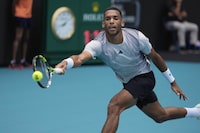 Felix Auger-Aliassime, of Canada, races for a ball from Adam Walton, of Australia, in their men's first round match at the Miami Open tennis tournament, Thursday, March 21, 2024, in Miami Gardens, Fla. (AP Photo/Rebecca Blackwell)