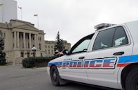 A Regina Police Service car idles at the legislative building in Regina, Saskatchewan on Wednesday, October 22, 2014.&nbsp;A man faces two attempted murder charges after police in Regina say they found a woman with stab wounds, and that when they tried to speak with a suspect in his truck nearby, he allegedly floored the vehicle in reverse and ran over the woman.&nbsp;THE CANADIAN PRESS/Michael Bell