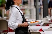 A waitress serves pasta in a restaurant in Milan, northern Italy, Thursday, June 8, 2023. Italians are calling for a pasta protest as food prices squeeze Europe. Grocery prices have risen more sharply in Europe than in other advanced economies from the U.S. to Japan, driven by higher energy and labor costs and the impact of Russia's war in Ukraine. (AP Photo/Luca Bruno)